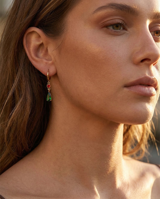 delicate gold hoop earrings with green gem pendant