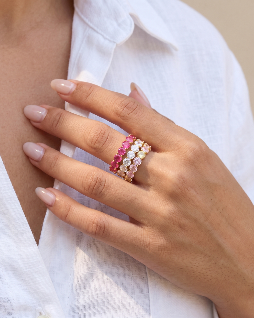 18K gold zircon eternity band rings in different colours worn on each finger by Clarabelle