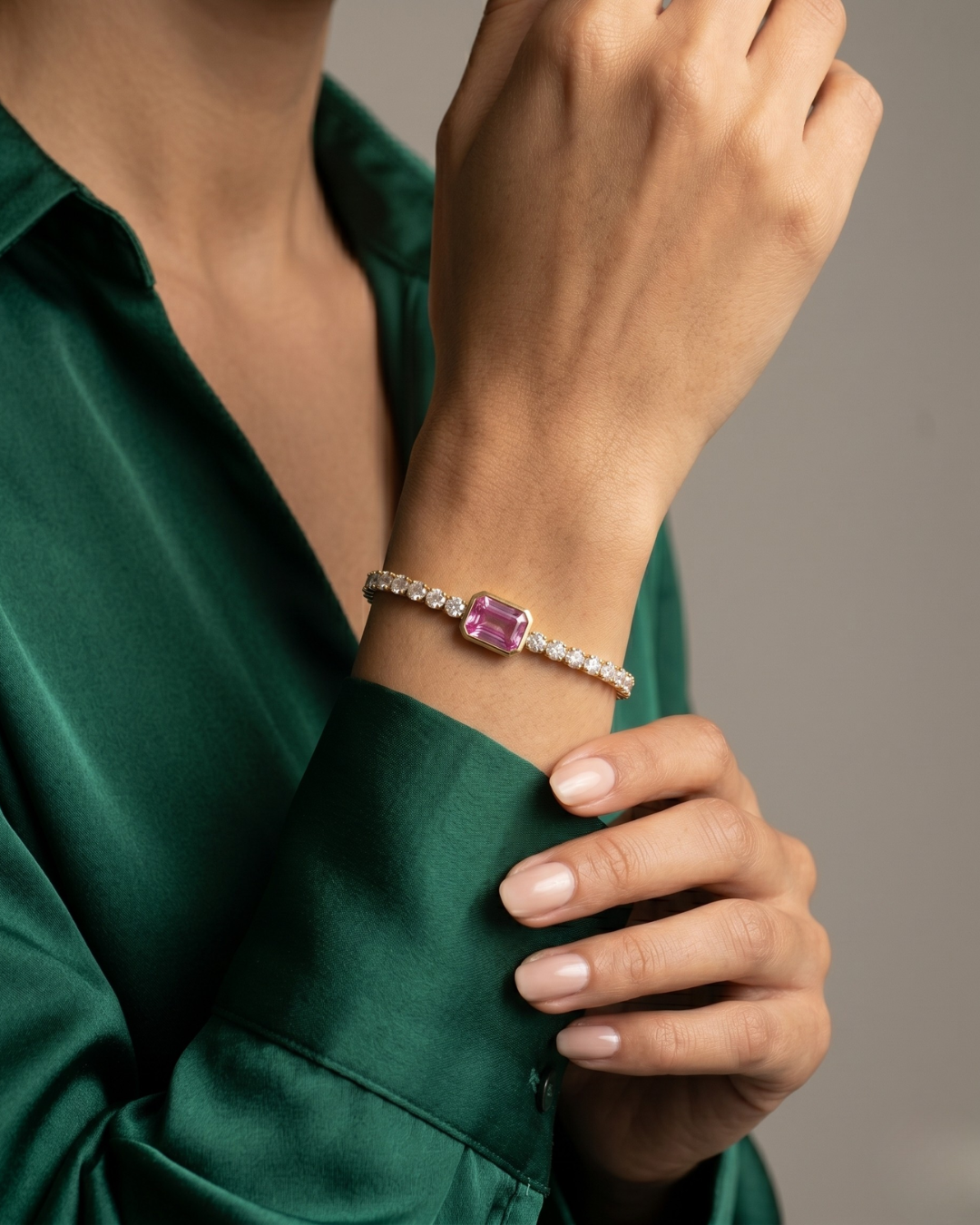 The Isabelle Bracelet by Clarabelle is femininity at its most refined. A continuous row of sparkling white zircon stones wraps around the wrist, all leading to a bold pink rectangular