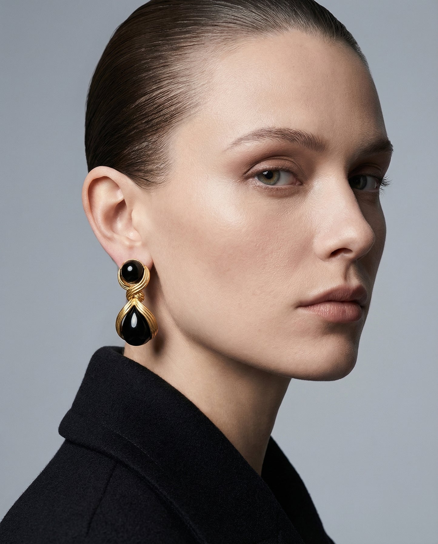 Model wearing Luna Black Statement Drop Earrings by Clarabelle — gold and black earrings