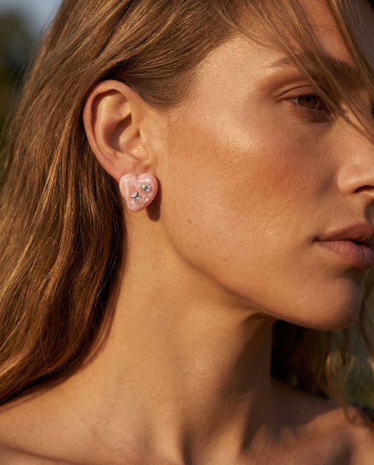glossy pink heart earrings worn by model