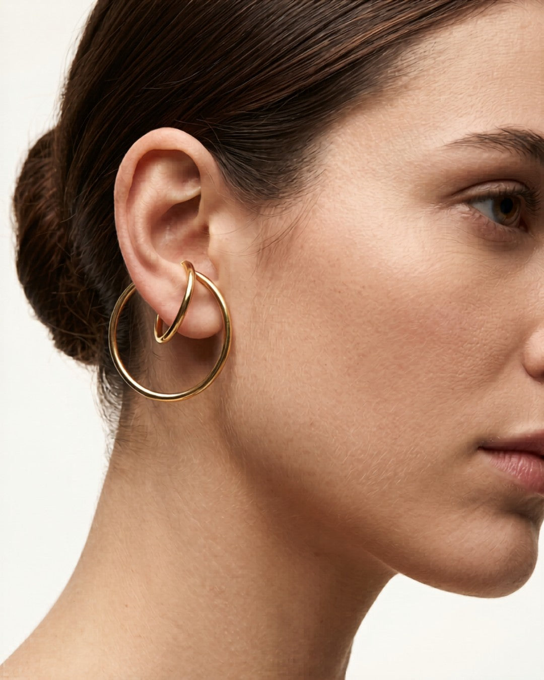 Gold ear cuff worn on ear without piercing — modern jewellery alternative by Clarabelle
