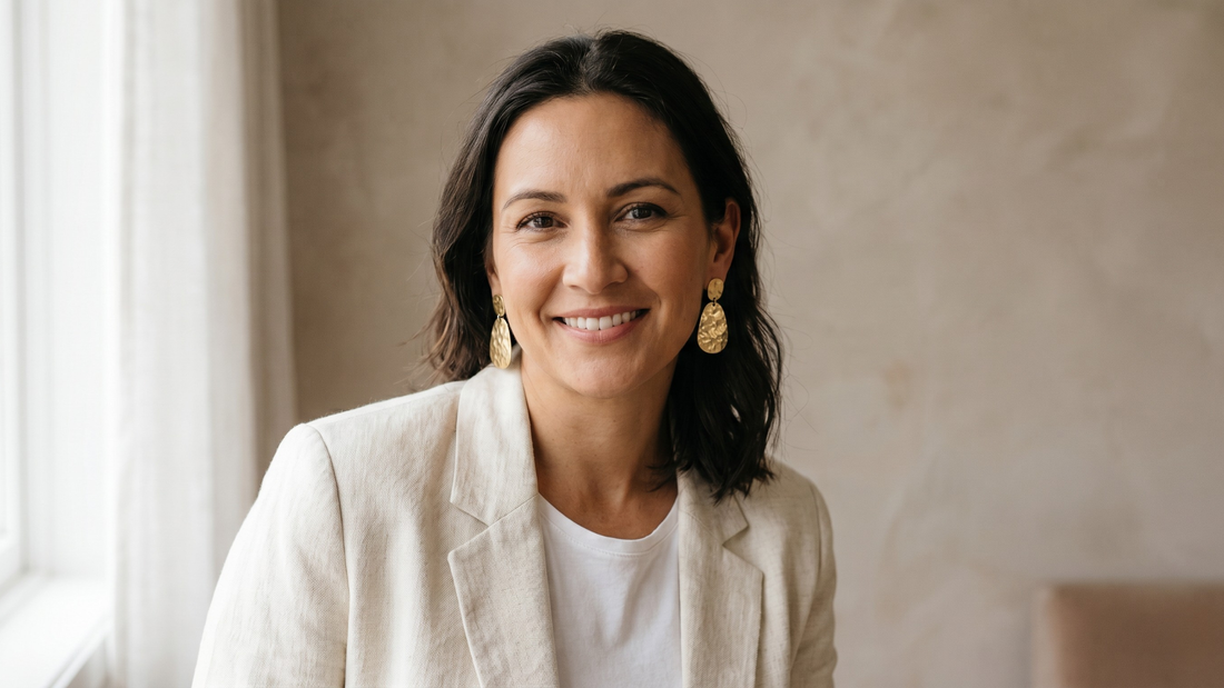 Confident woman wearing gold drop earrings — psychology of self-purchase 