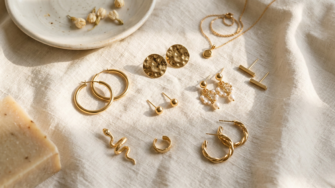 Gold earrings flat lay on cream linen — 10 life moments that deserve to be marked