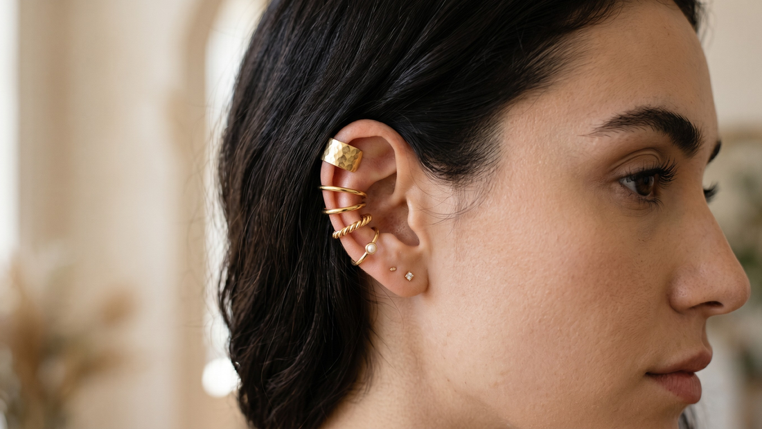 Woman with stacked gold ear cuffs no piercing — how to build an ear stack without piercing 