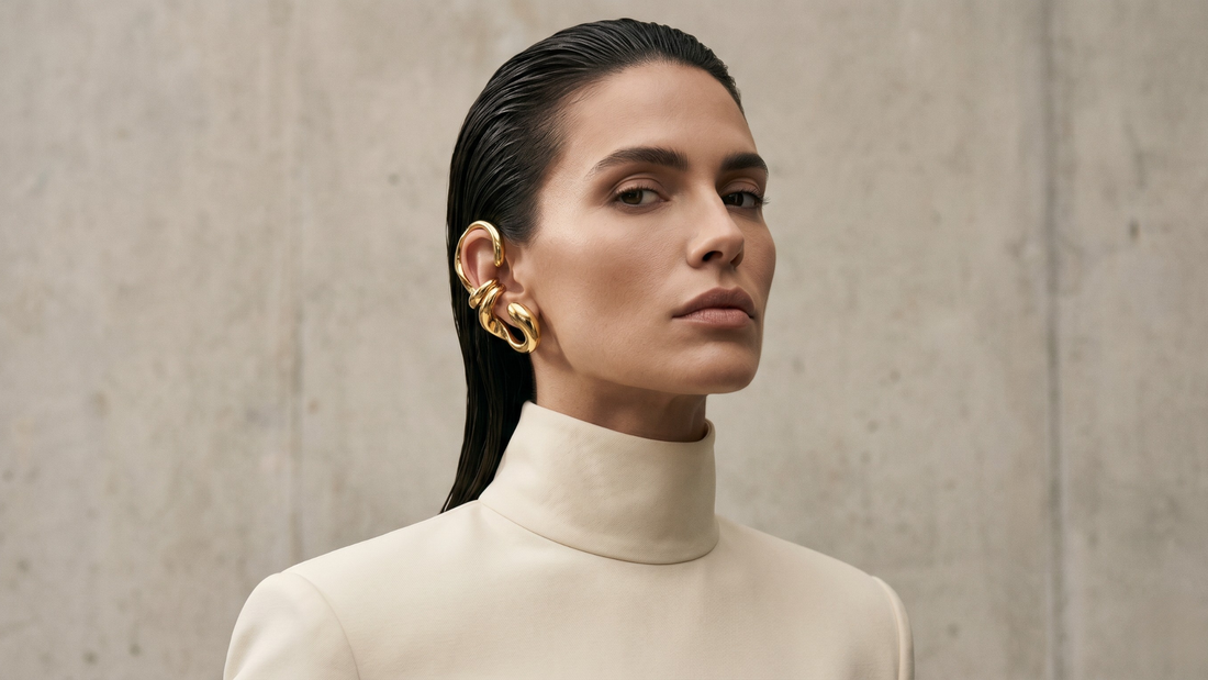 Woman with slicked hair wearing bold gold ear cuff — how to style ear cuffs 10 looks
