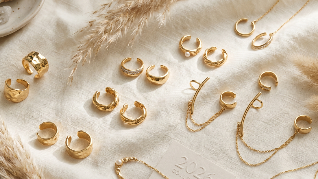 Gold ear cuffs flat lay on linen — no piercing jewellery movement 2026