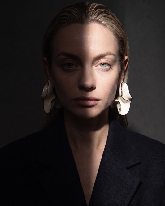 Woman wearing gold statement earrings celebrating a career promotion — Clarabelle Her Promotion collection