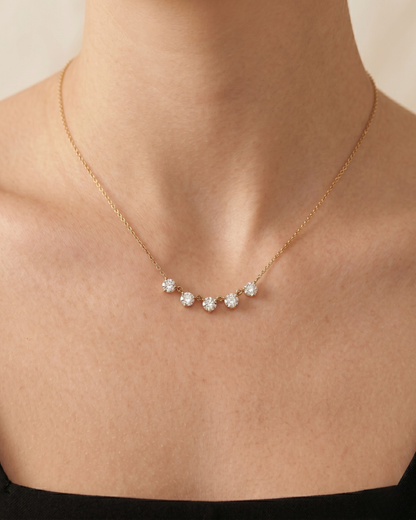 Close-up of Estelle necklace pendants, five faceted crystal-set stones in gold-plated settings