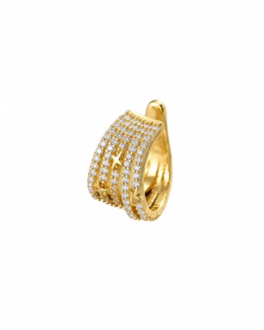 Esme non-piercing ear cuff in gold-tone with dense pavé crystal and hidden five-pointed star detail, laid flat on neutral background