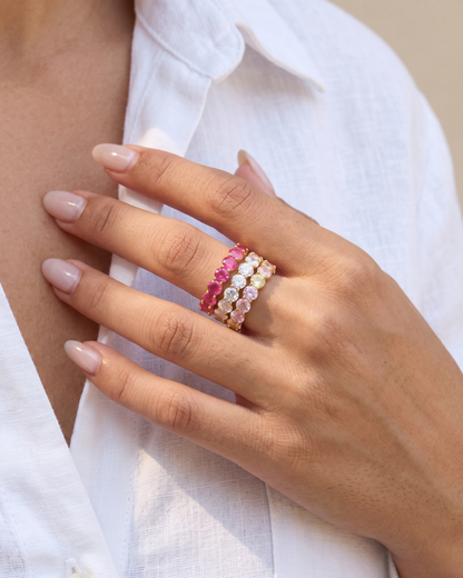 18K gold zircon eternity band rings in different colours worn on each finger by Clarabelle