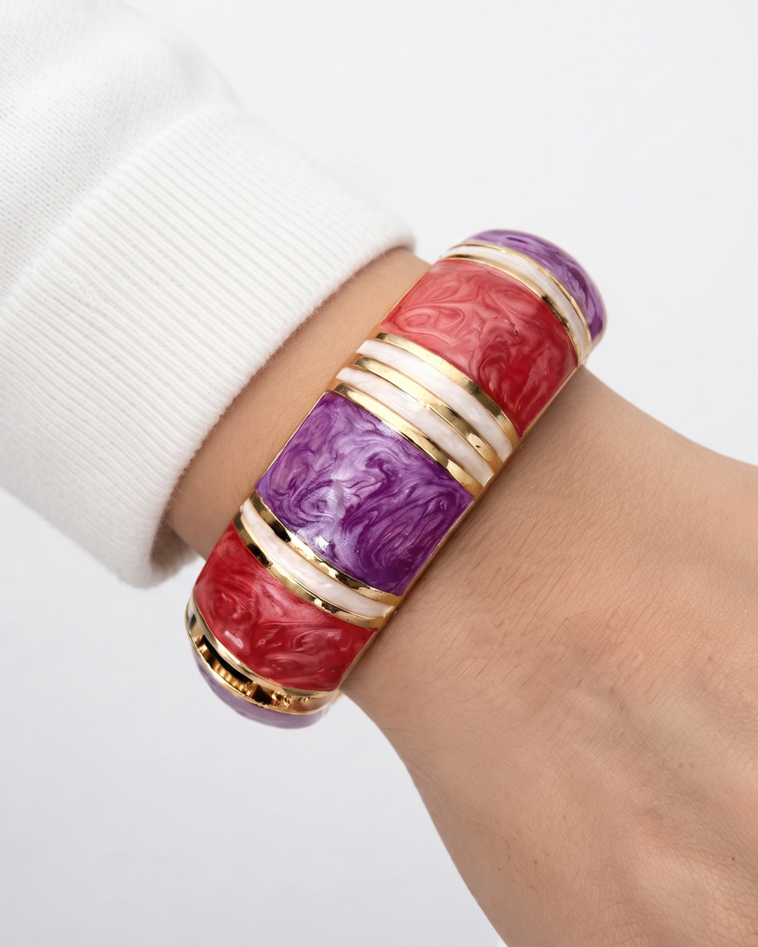 Fiamma marbled statement bangle in crimson, violet and cream with polished gold-tone banding, laid flat on neutral background