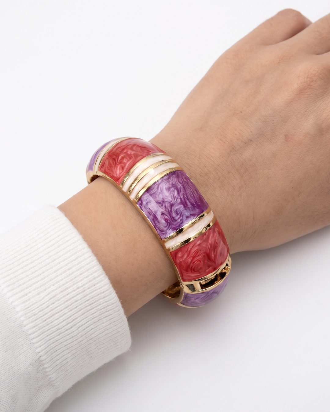 Fiamma bangle worn on the wrist with a soft white shirt cuff, close view