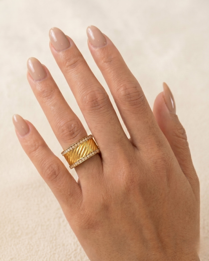Helena ring worn on the finger, sculpted twisted band with double pavé lines