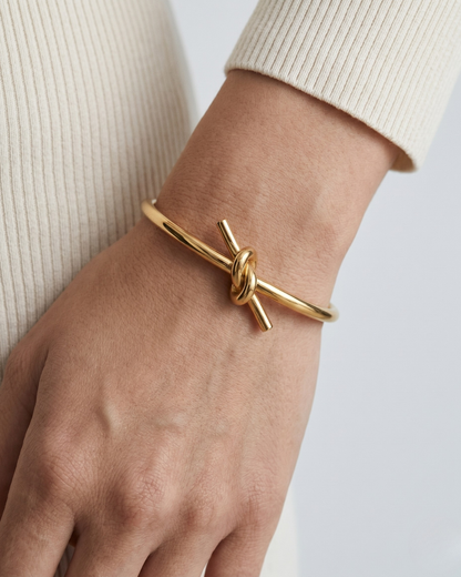 The Knot Cuff Bracelet by Clarabelle is the definition of effortless elegance. A single, sculptural knot sits at the centre of a sleek open cuff