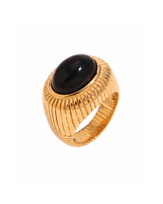 Siena signet ring in gold-tone stainless steel with black onyx cabochon and fluted dome band, laid flat on neutral background