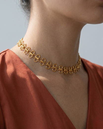 The Palermo Necklace by Clarabelle is a statement piece that speaks for itself. Interlocking four-leaf clover links in warm gold