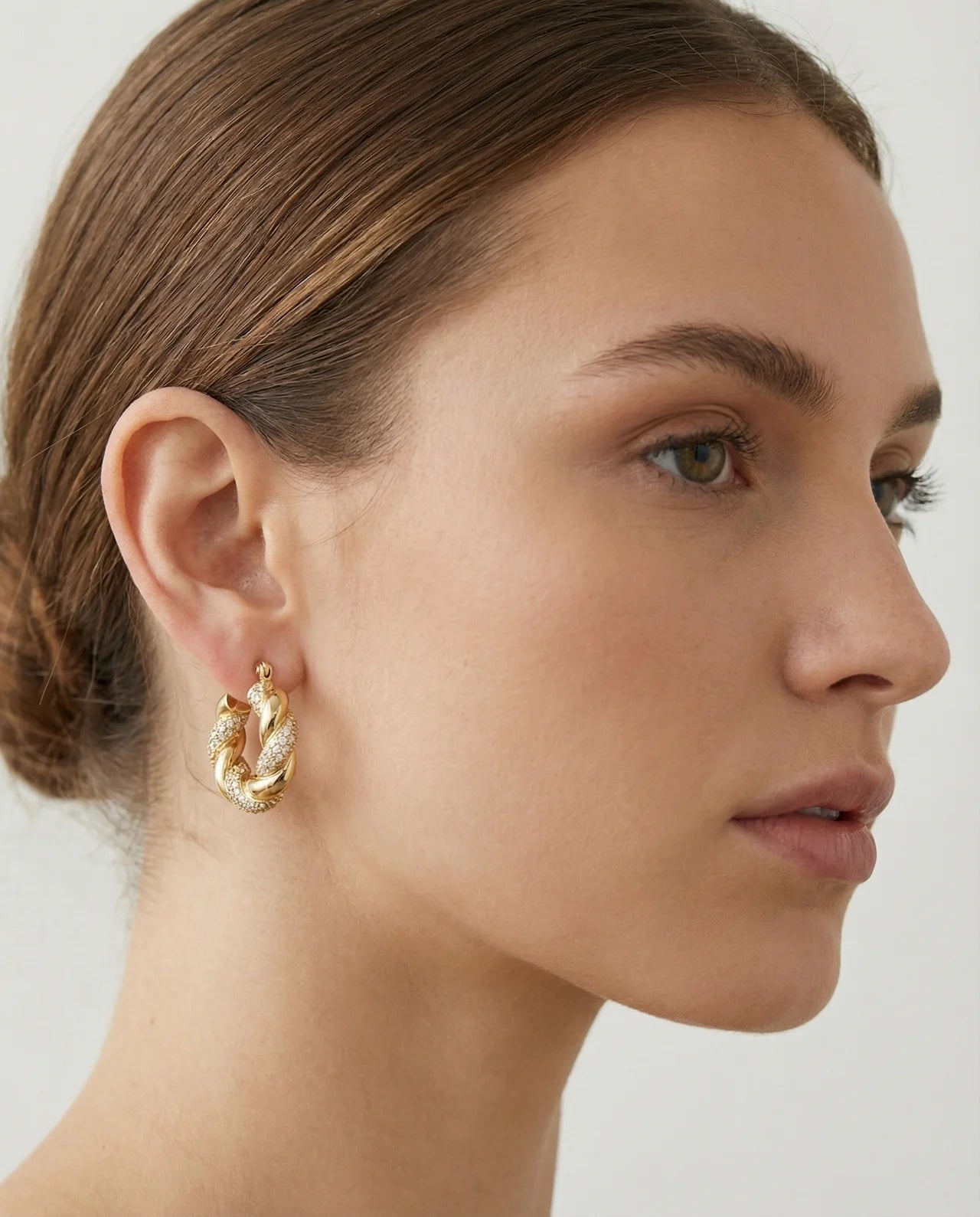 Twisted Hoop Earrings - 18K Gold Plated Twisted Hoop Earrings on ear