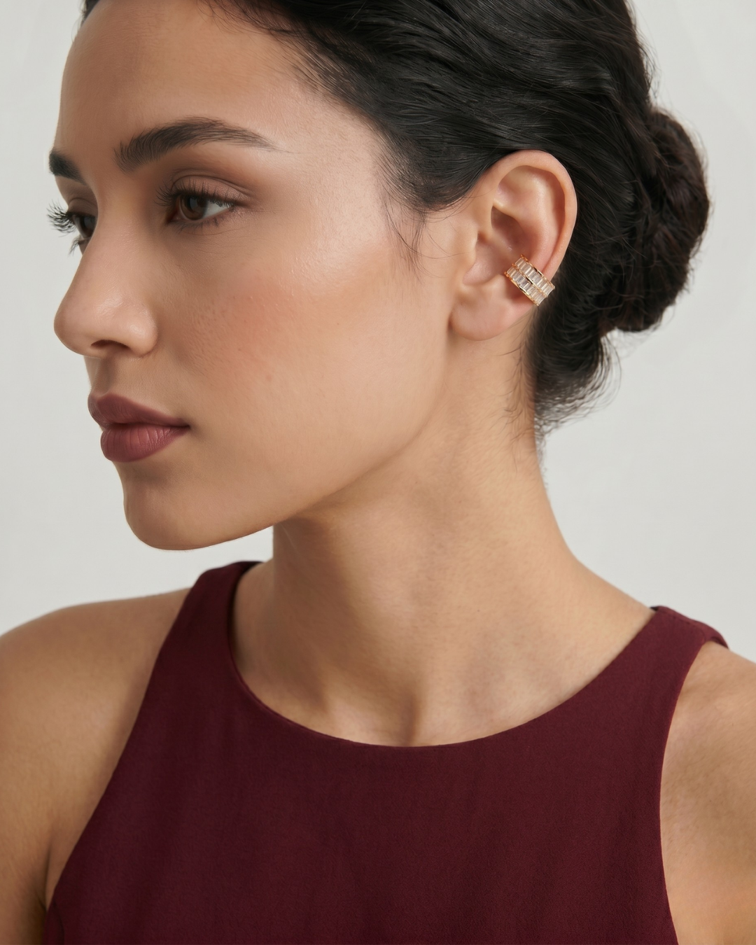Woman wearing a gold double row stone-effect ear cuff, close-up on ear, minimal white top, soft natural light — Sydney Ear Cuff by Clarabelle
