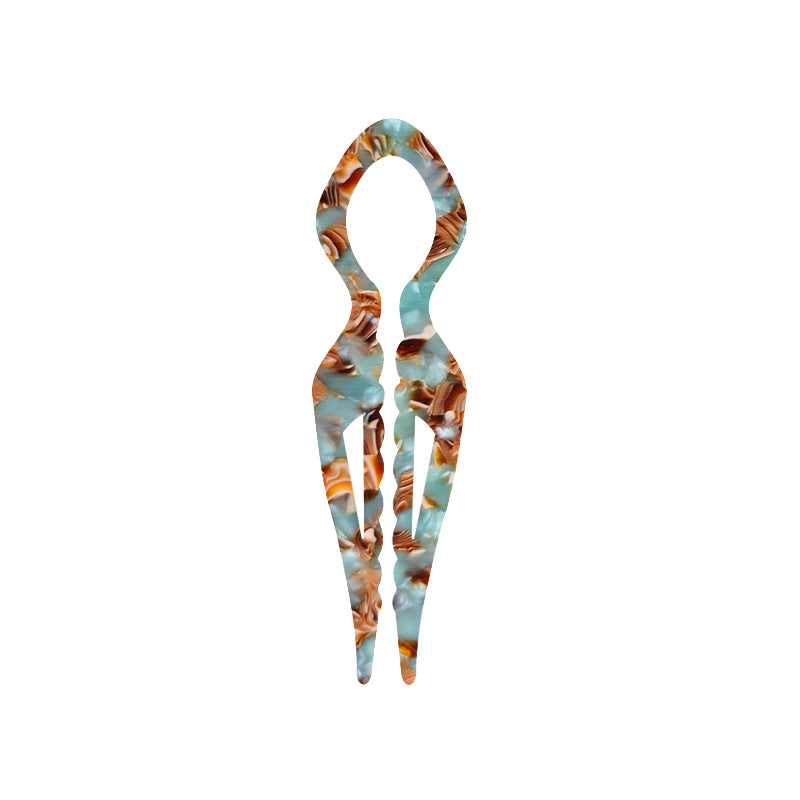 Margot sculpted acetate hair fork in brown floral pattern with lyre silhouette and two tapered tines, laid flat on neutral background