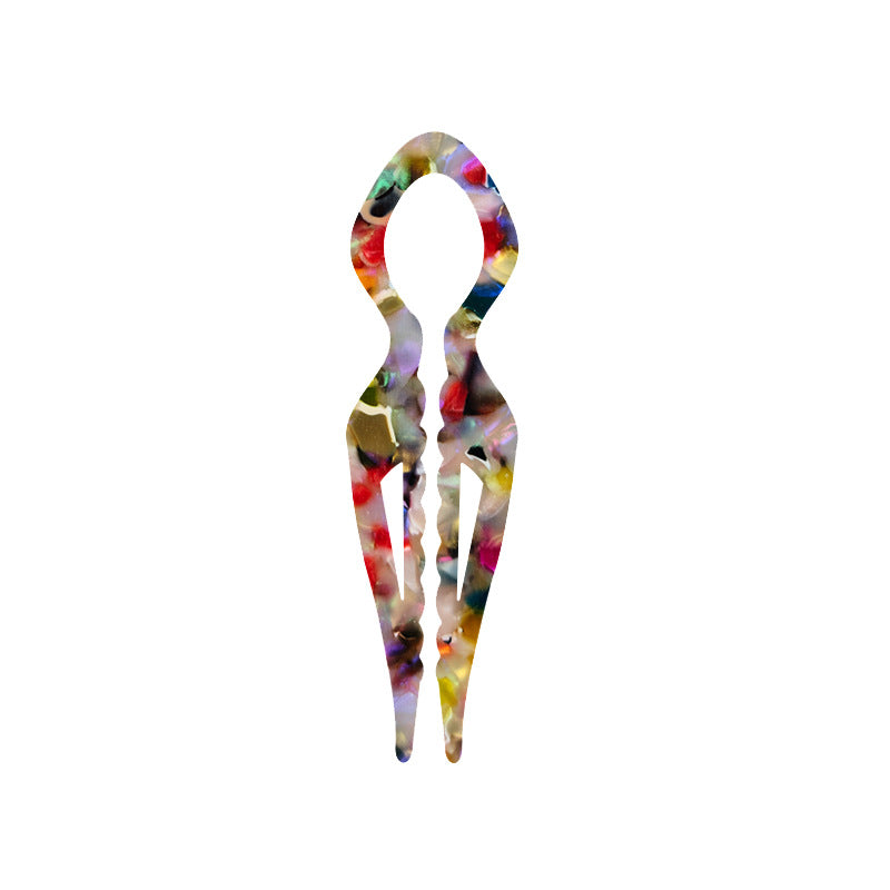 Margot sculpted acetate hair fork in multicolour floral pattern with lyre silhouette and two tapered tines, laid flat on neutral background