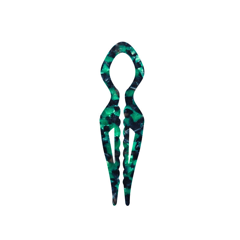 Margot sculpted acetate hair fork in emerald green marble with lyre silhouette and two tapered tines, laid flat on neutral background
