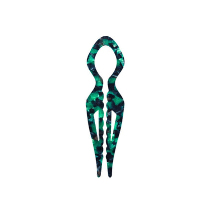 Margot sculpted acetate hair fork in emerald green marble with lyre silhouette and two tapered tines, laid flat on neutral background