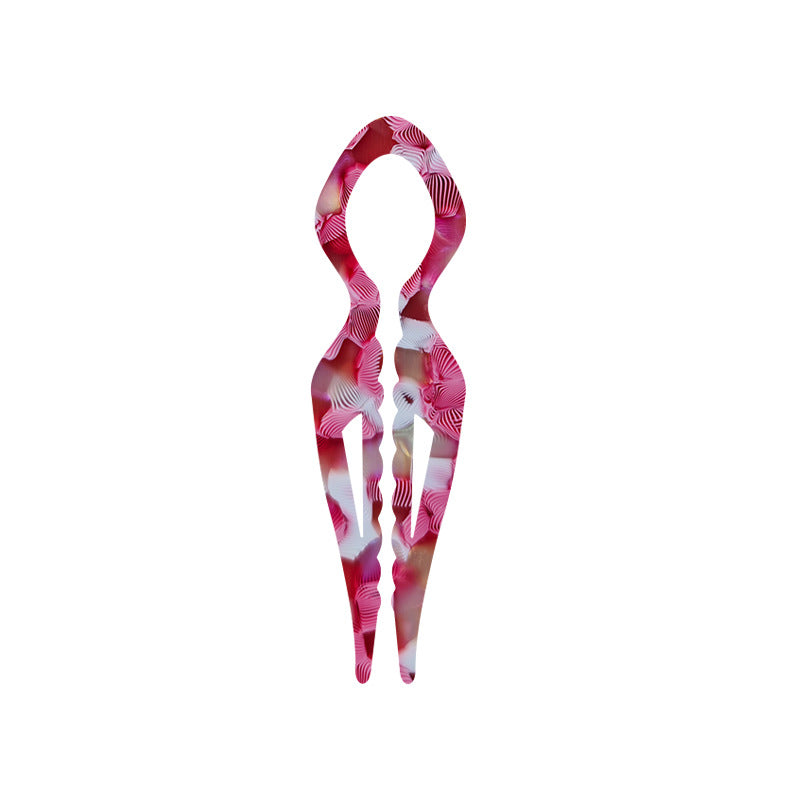 Margot sculpted acetate hair fork in pink floral pattern with lyre silhouette and two tapered tines, laid flat on neutral background